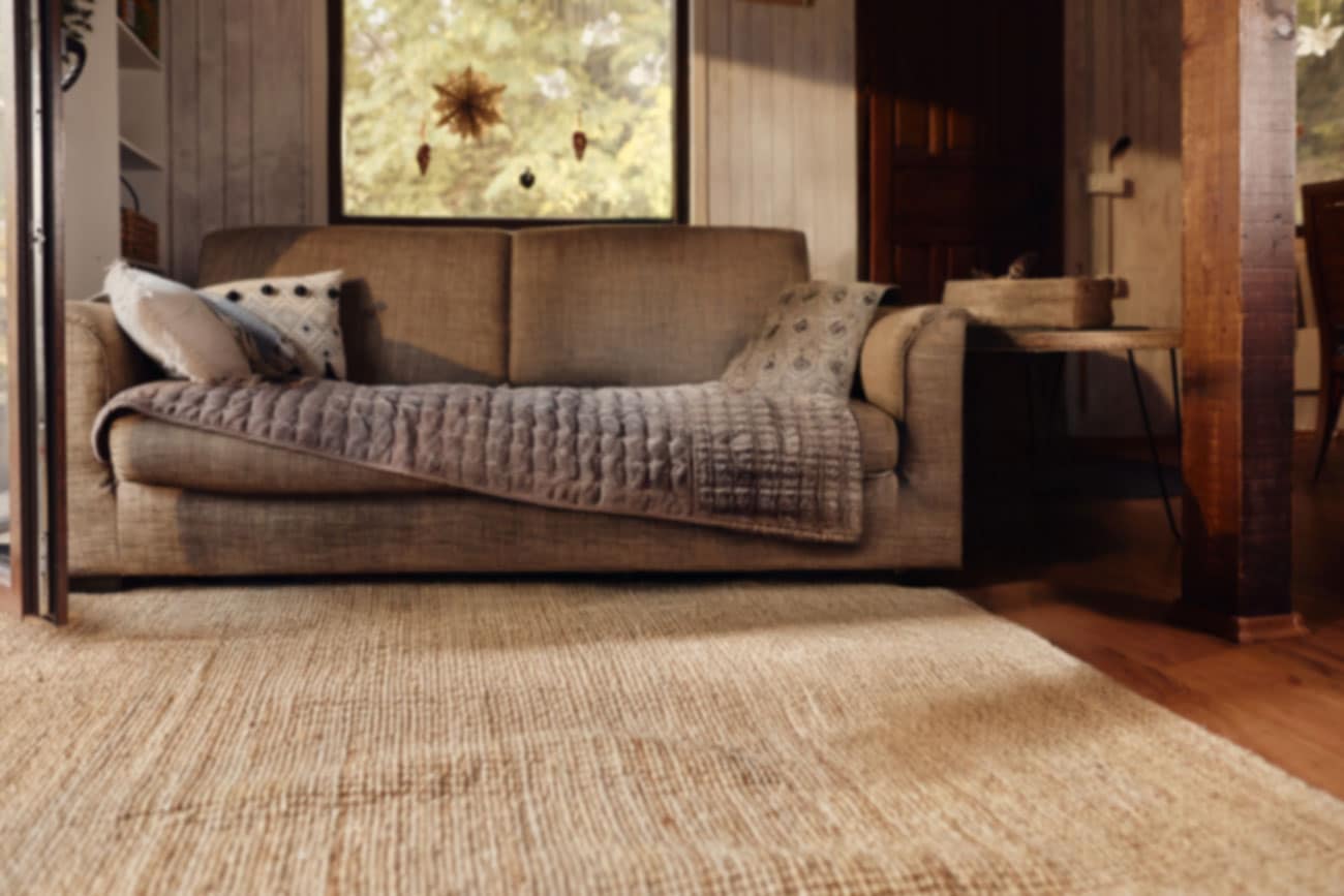 Living room background with couch in front of window.