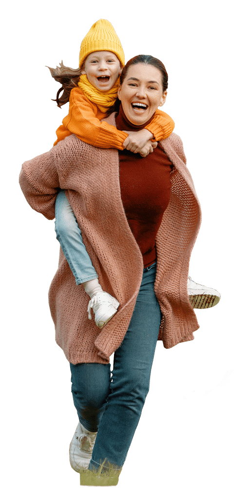 Woman carrying young daughter on her back running through grassy field; heating services.